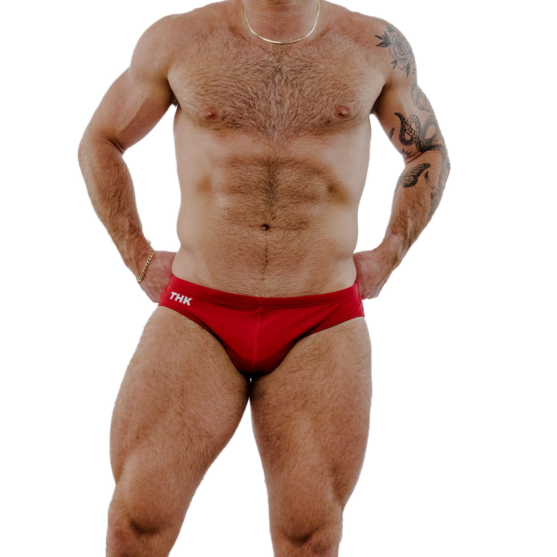 Man wearing red swimsuit with 'THK' branding on a white background