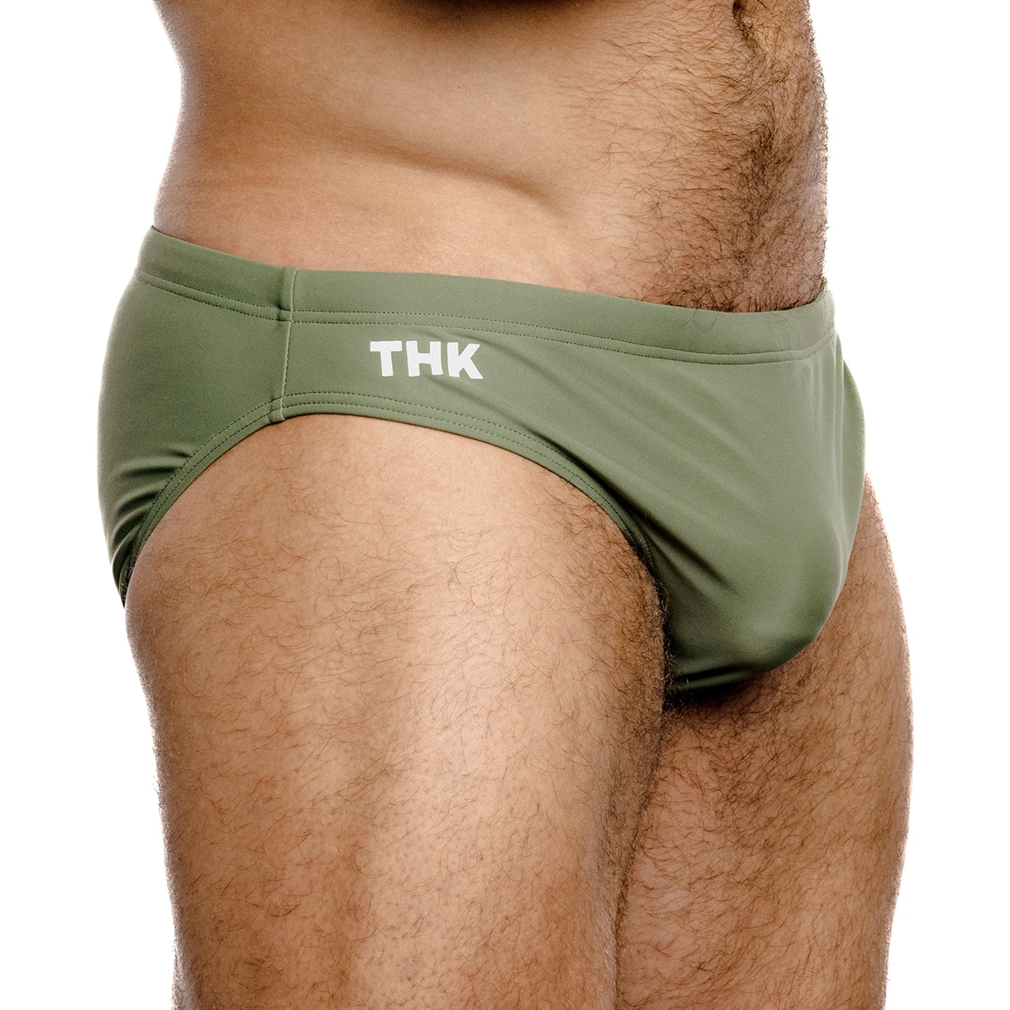 Green men's swimwear with 'THK' branding on a white background