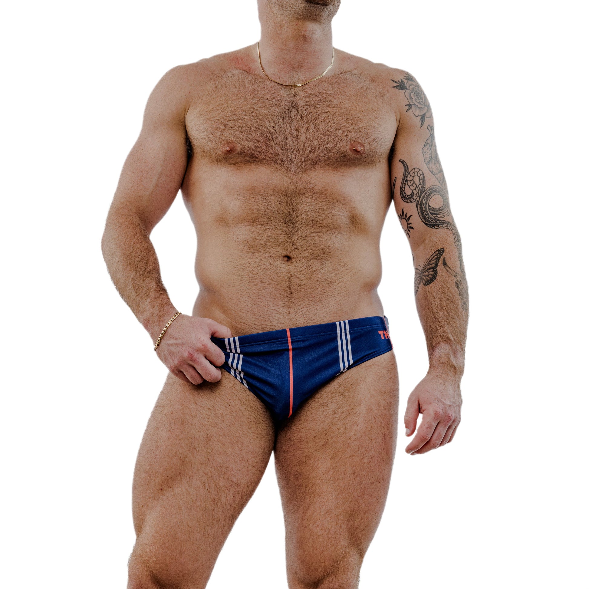Man wearing a blue swim brief with white and red stripes on a white background
