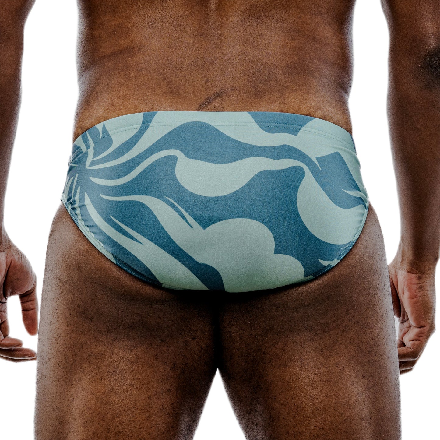 Blue patterned swim brief on a person against a white background