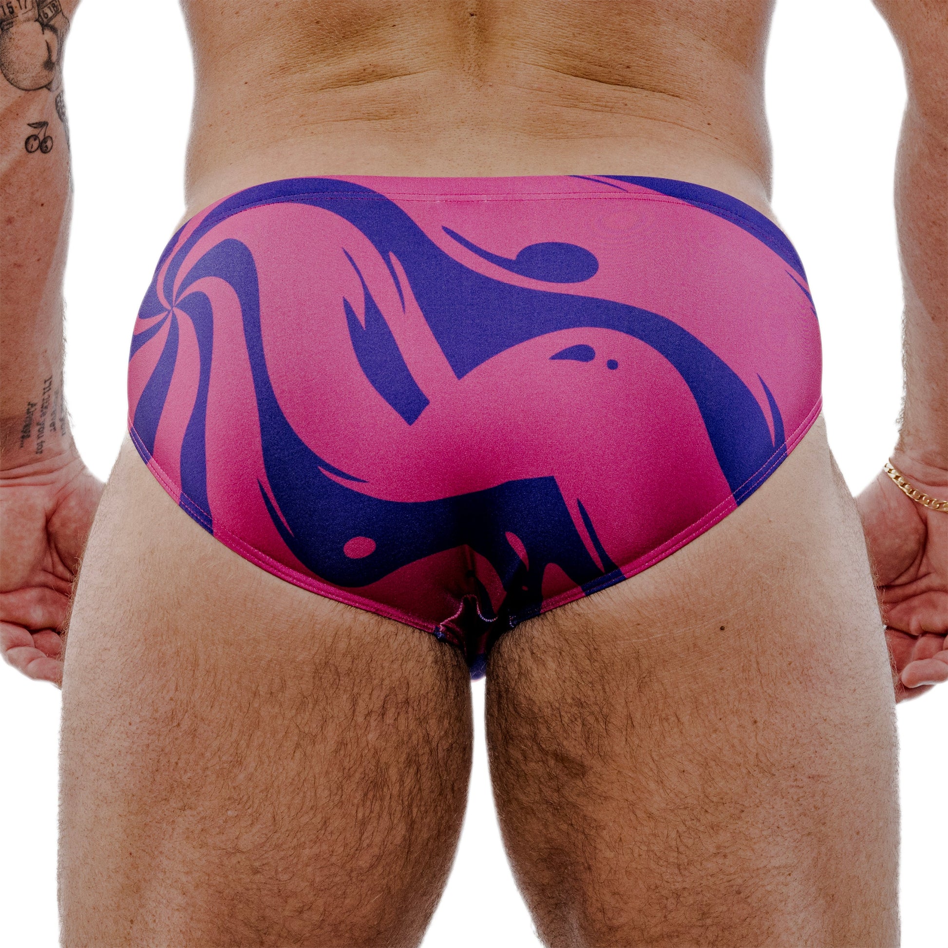 Pink and blue speedos on a person against a white background