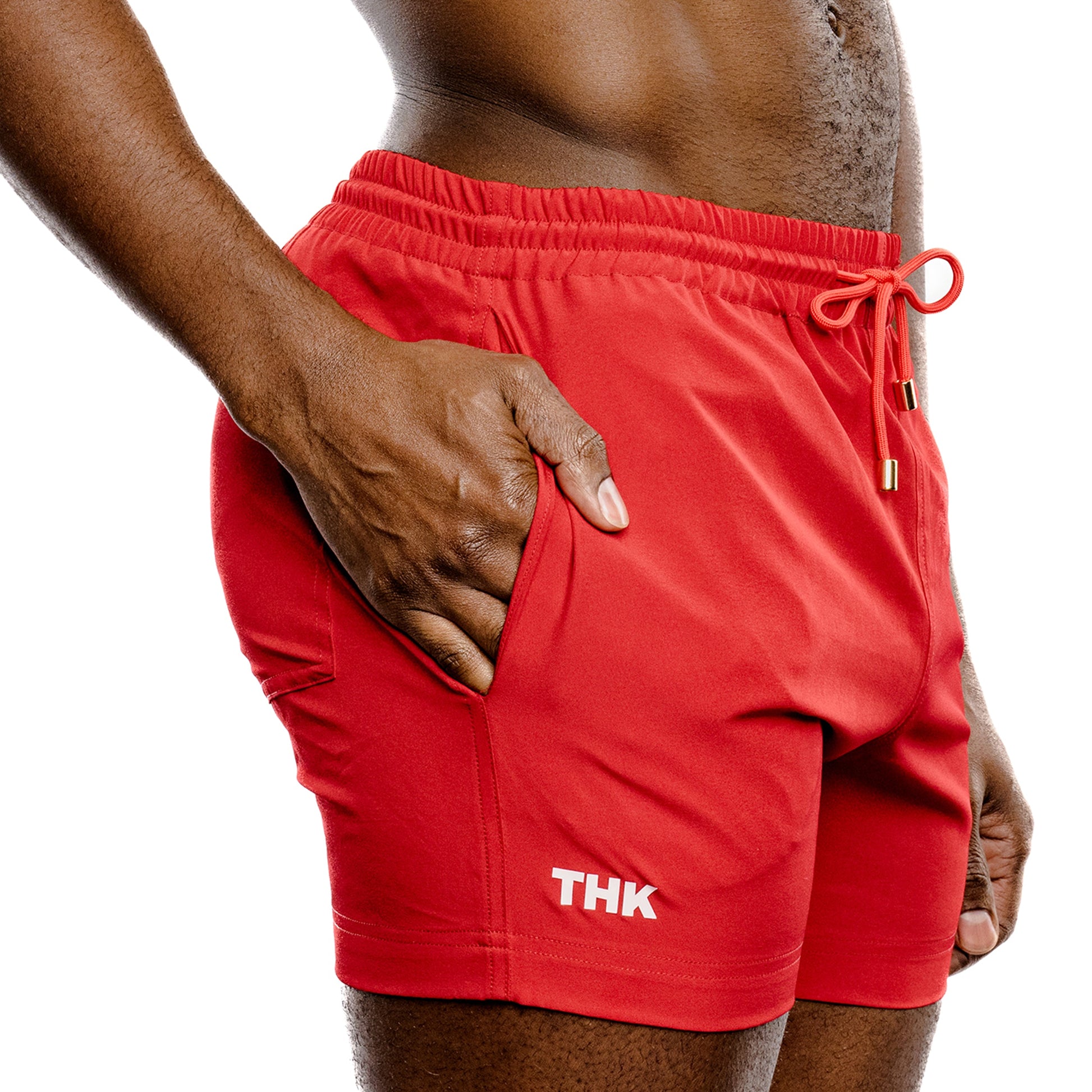 Red men's swim wear with 'THK' branding on a white background