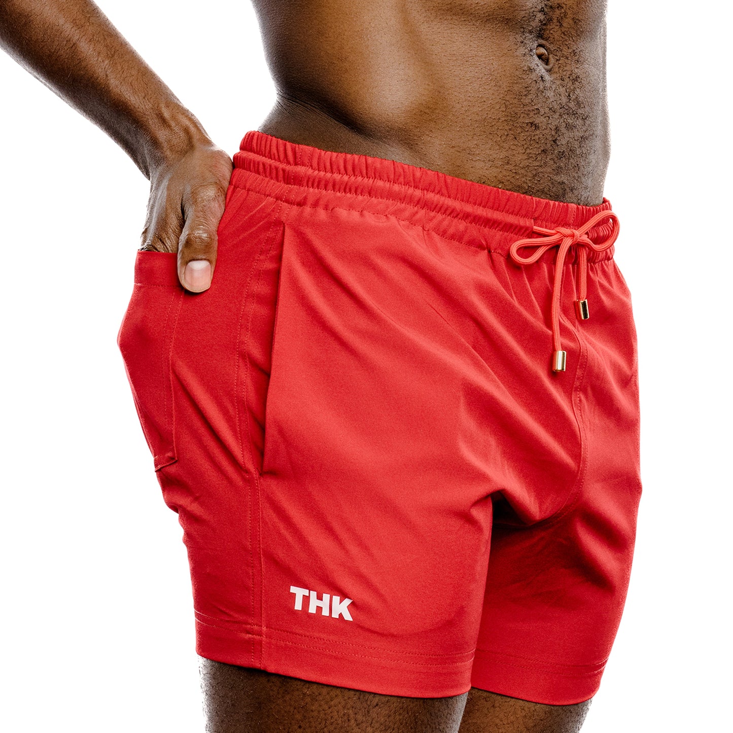 Red swim shorts with 'THK' branding on a white background