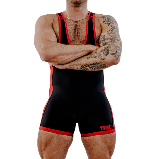 Person wearing a black and red wrestling singlet with 'THC' branding on a white background