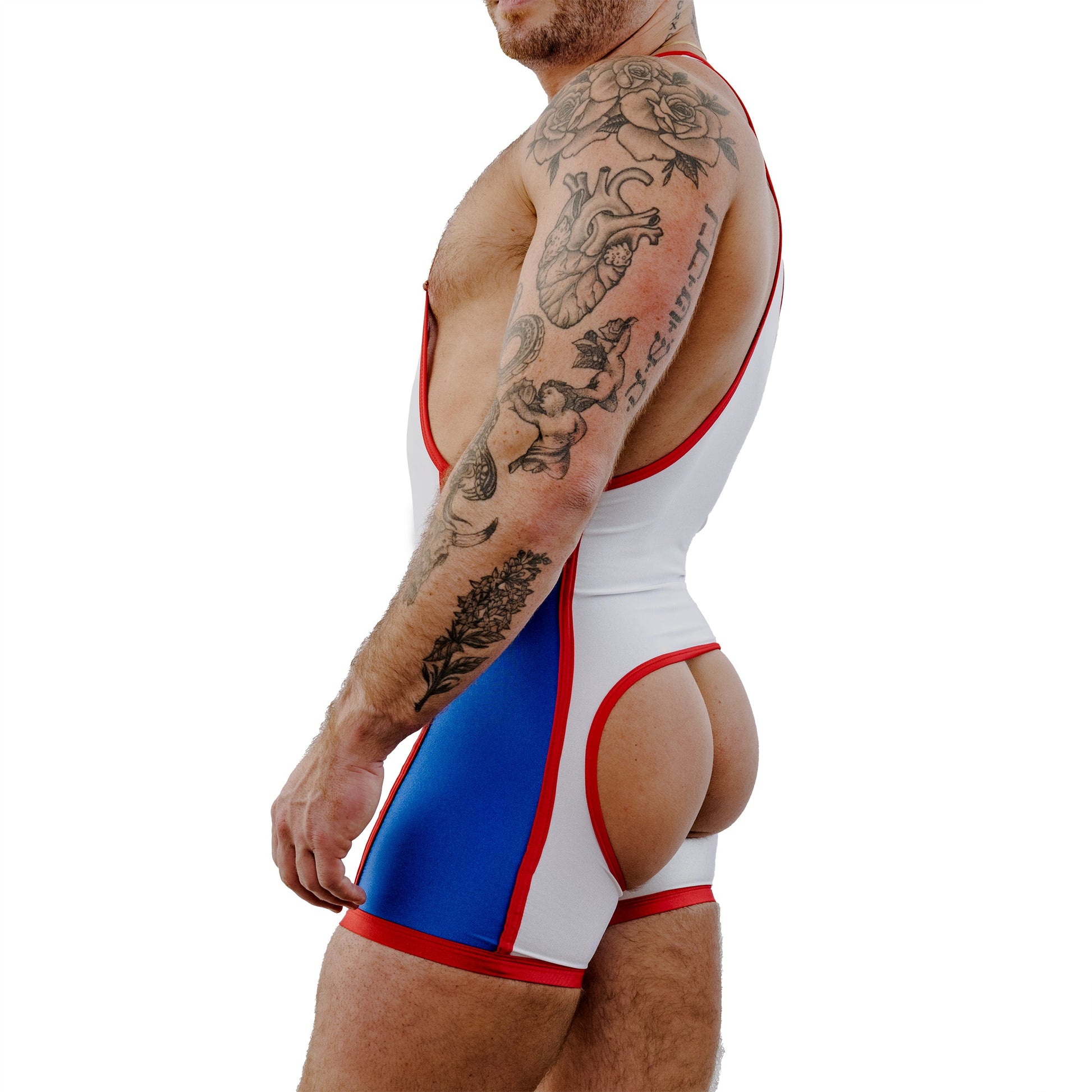 Man wearing a white, red, and blue swimsuit with tattoos on his arms.