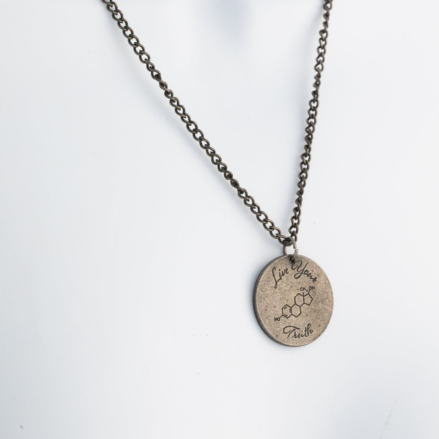 Necklace with a round pendant on a mannequin against a white background