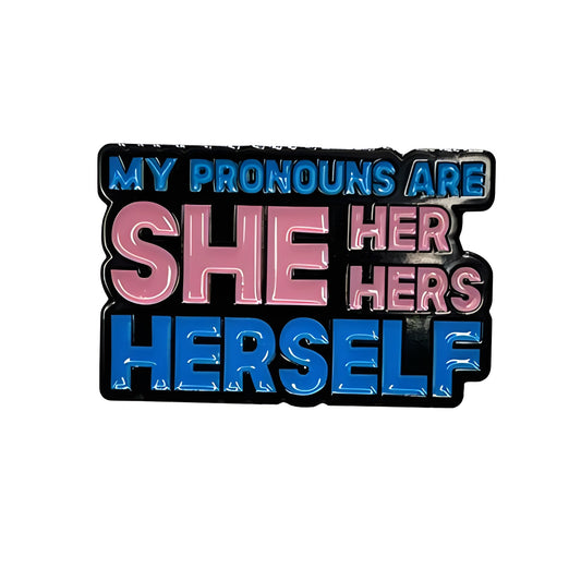 Lapel Pin with 'My pronouns are she/her/hers/herself' text in trans pride colors on a white background