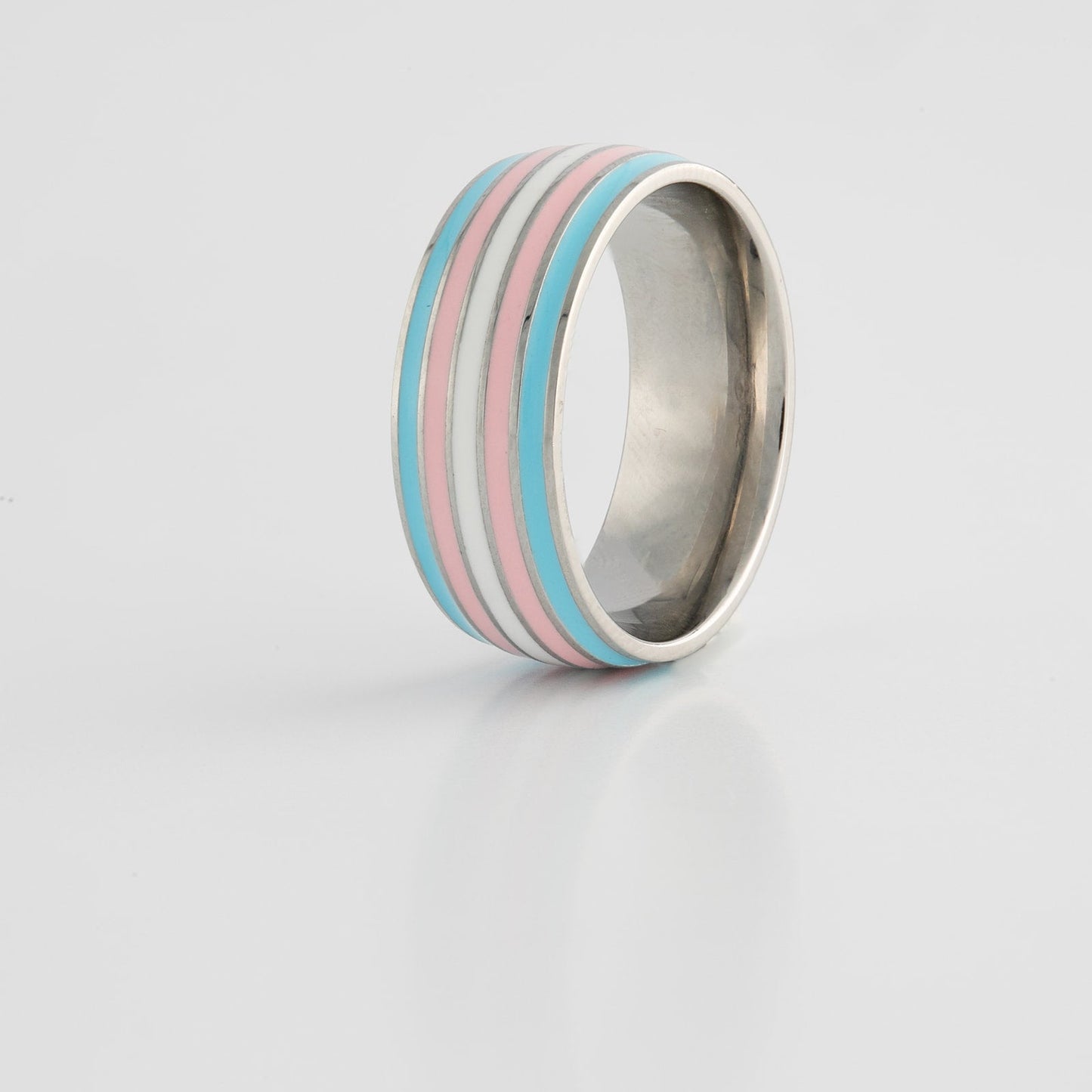 Ring with transgender pride stripes on a gray background