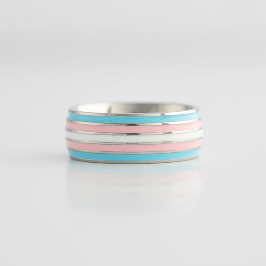 Silver ring with trans pride stripes on a light gray background