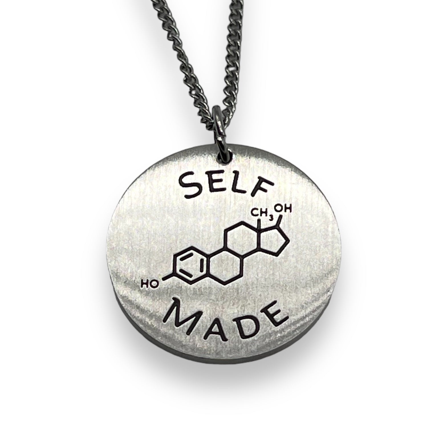 Trans necklace with a pendant featuring a chemical molecule for estrogen and 'SELF MADE' text on a white background