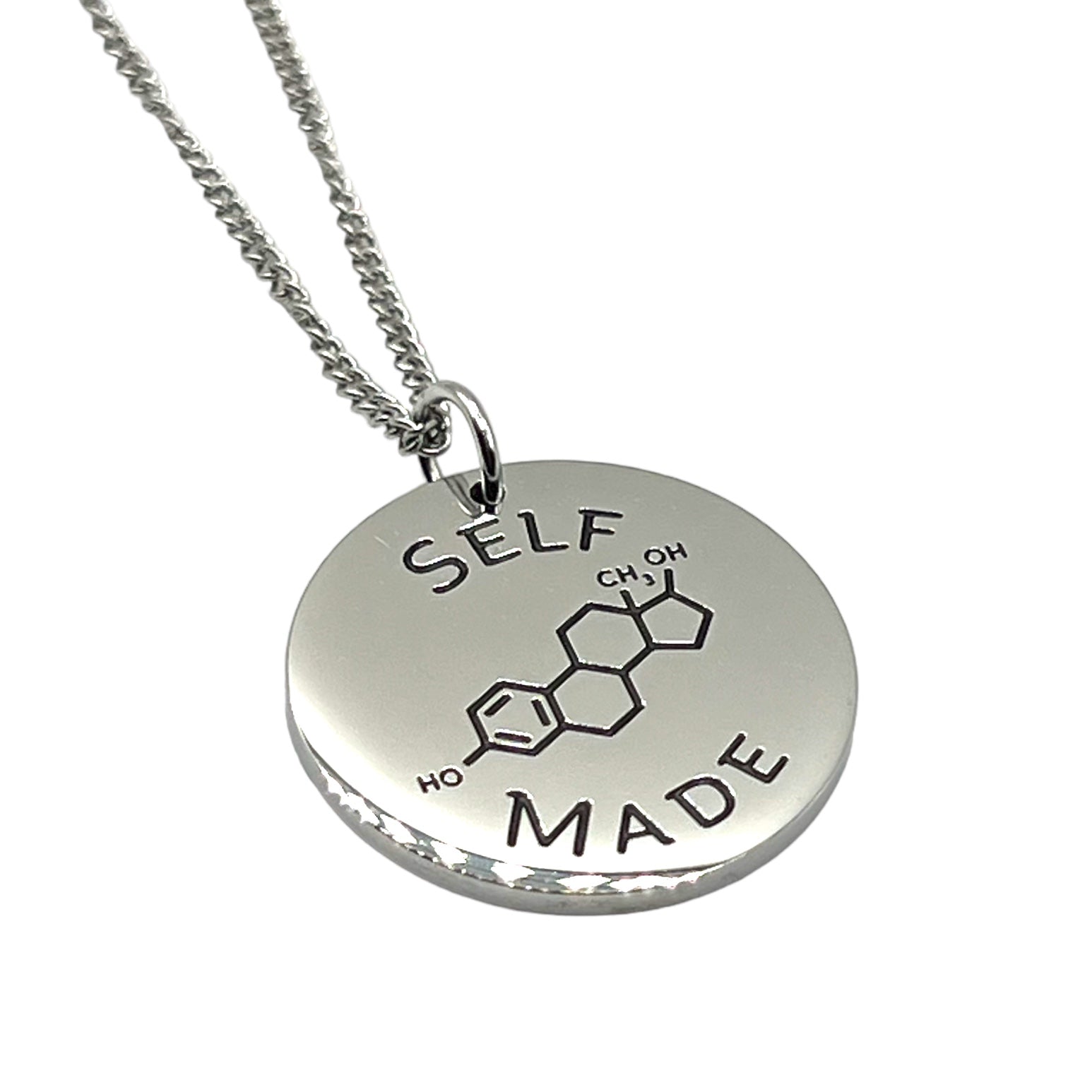 Silver necklace with a round pendant featuring chemical notation for estrogen and 'SELF MADE' text on a white background