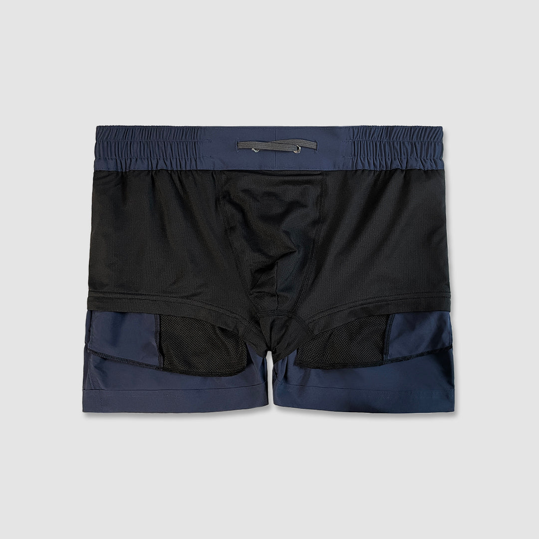 Inside-out detail of navy swim shorts on a light gray background