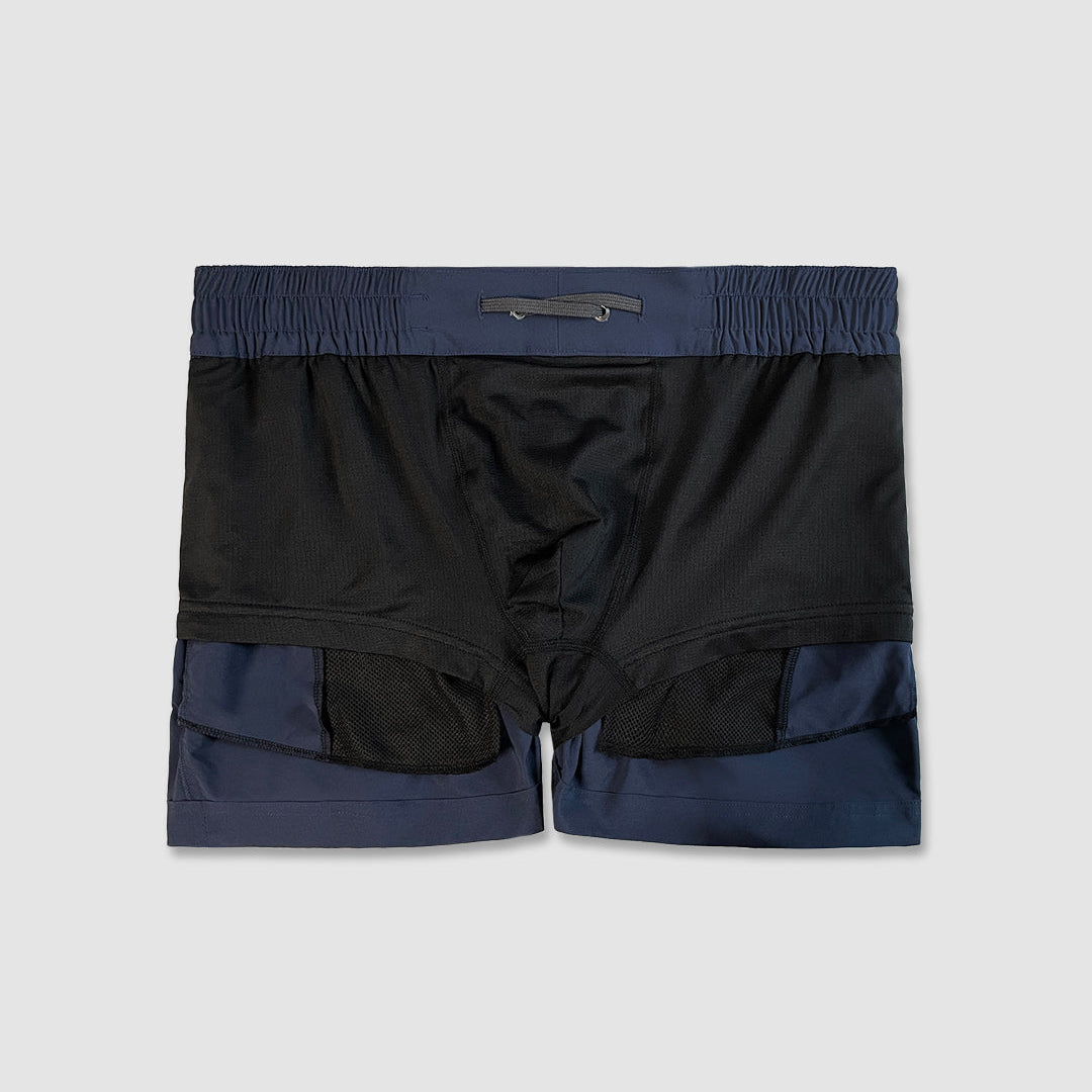 inside-out detail of navy swim shorts on a light gray background