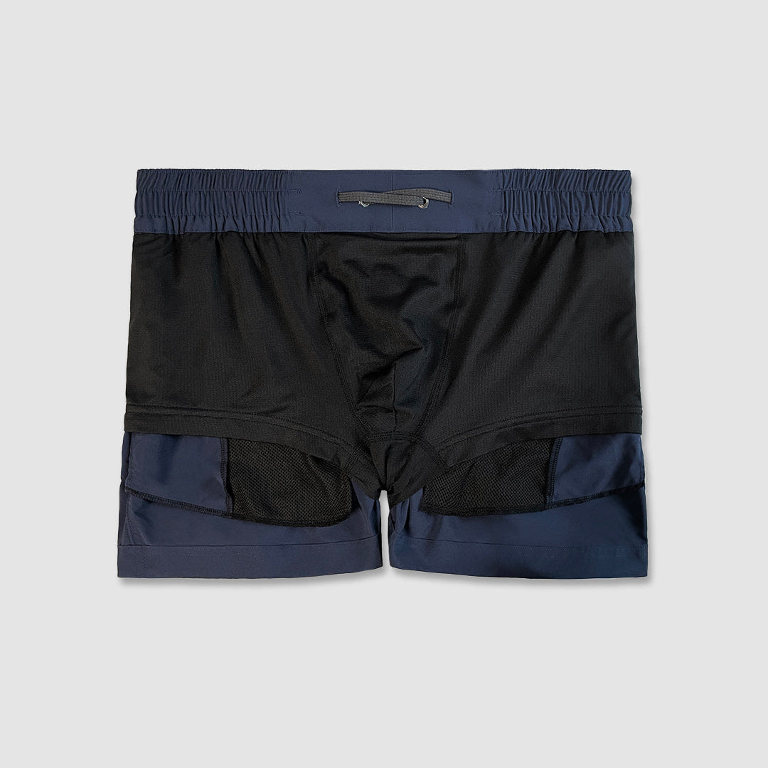 Inside-out detail of swim shorts on a light gray background